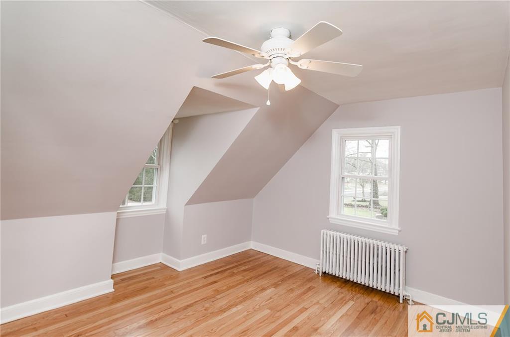 127 Plainsboro Road Cranbury, NJ 08512 - Photo 18 of 25 a view of an empty room with wooden floor and a window