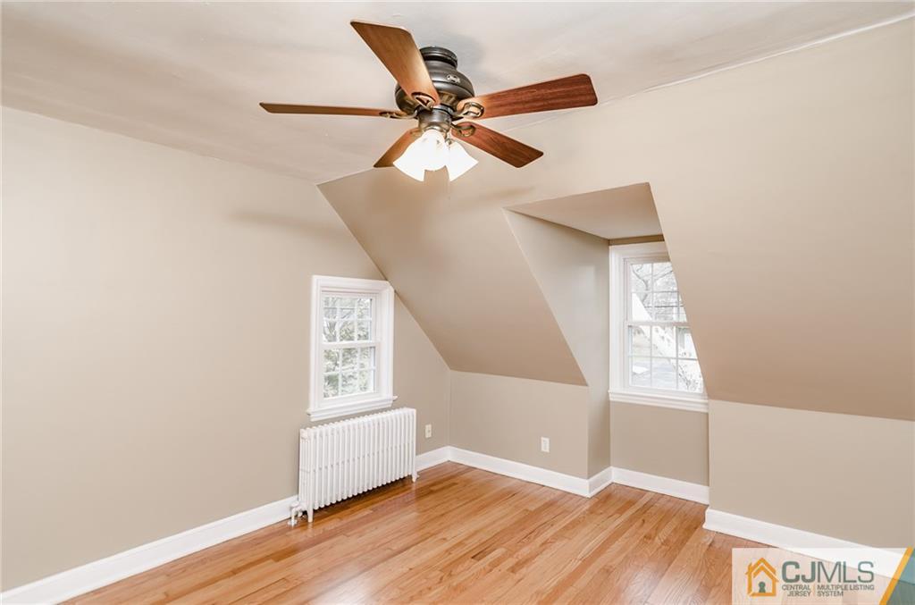 127 Plainsboro Road Cranbury, NJ 08512 - Photo 19 of 25 a view of an empty room with wooden floor and a window