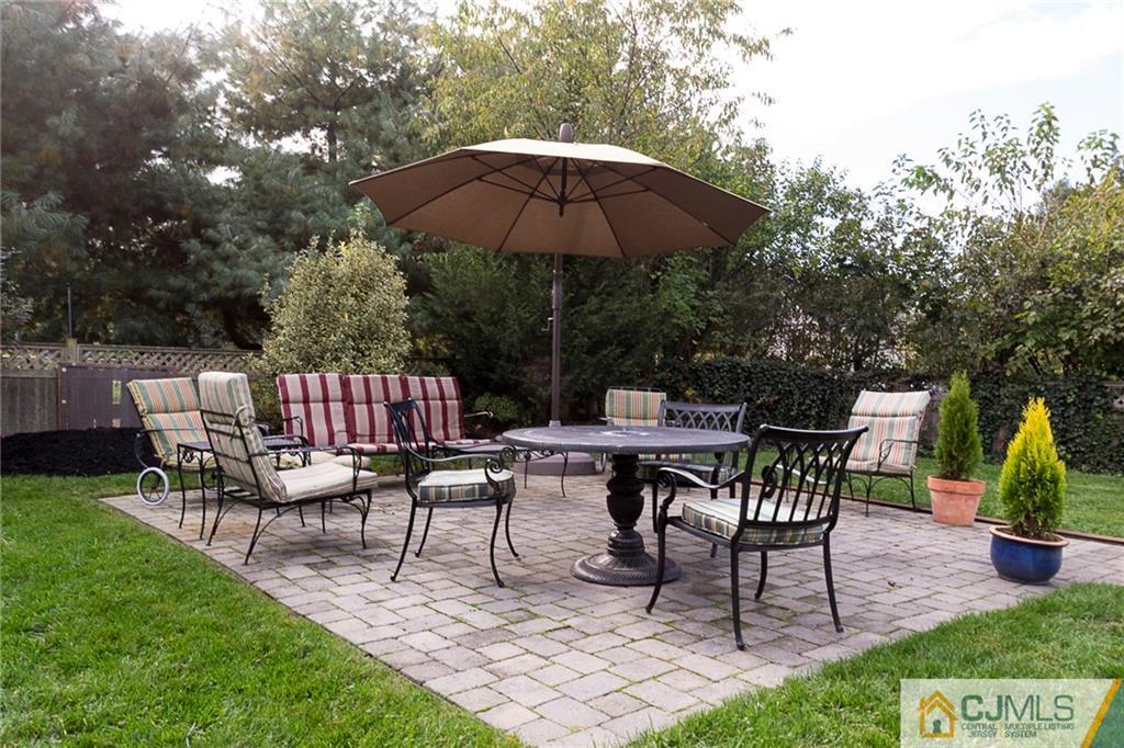 127 Plainsboro Road Cranbury, NJ 08512 - Photo 24 of 25 a view of a dinning table and chairs under an umbrella