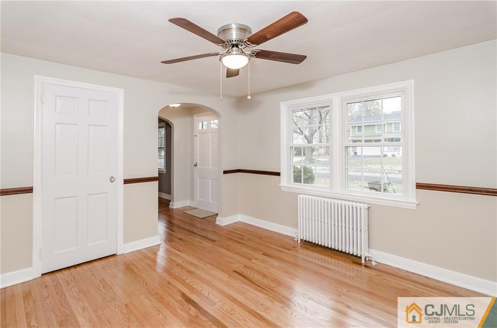 127 Plainsboro Road Cranbury, NJ 08512 - Photo 8 of 25 a view of an empty room with window and wooden floor