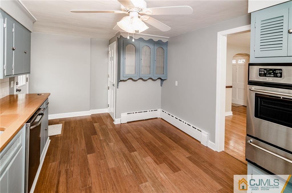 127 Plainsboro Road Cranbury, NJ 08512 - Photo 10 of 25 a view of a kitchen with wooden floor and electronic appliances
