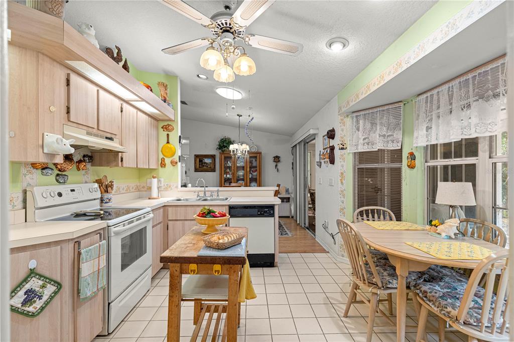 8534 Southwest 108th Pl Road Ocala, FL 34481 - Photo 12 of 41 a kitchen with stainless steel appliances kitchen island granite countertop a sink and cabinets