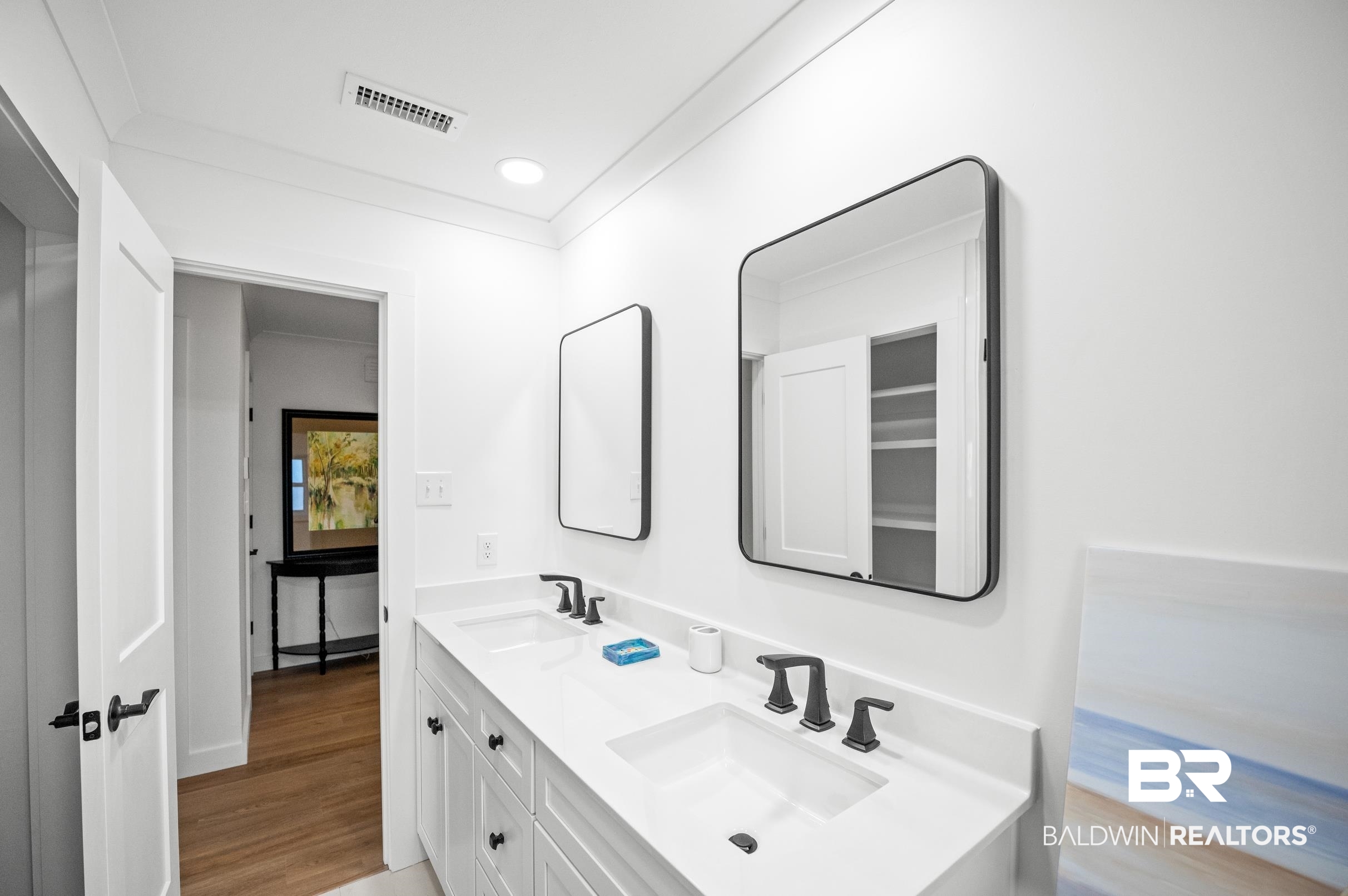 9459 Soldier Creek Road Lillian, AL 36549 - Photo 25 of 54 Bathroom with crown molding, visible vents, a sink, and wood finished floors