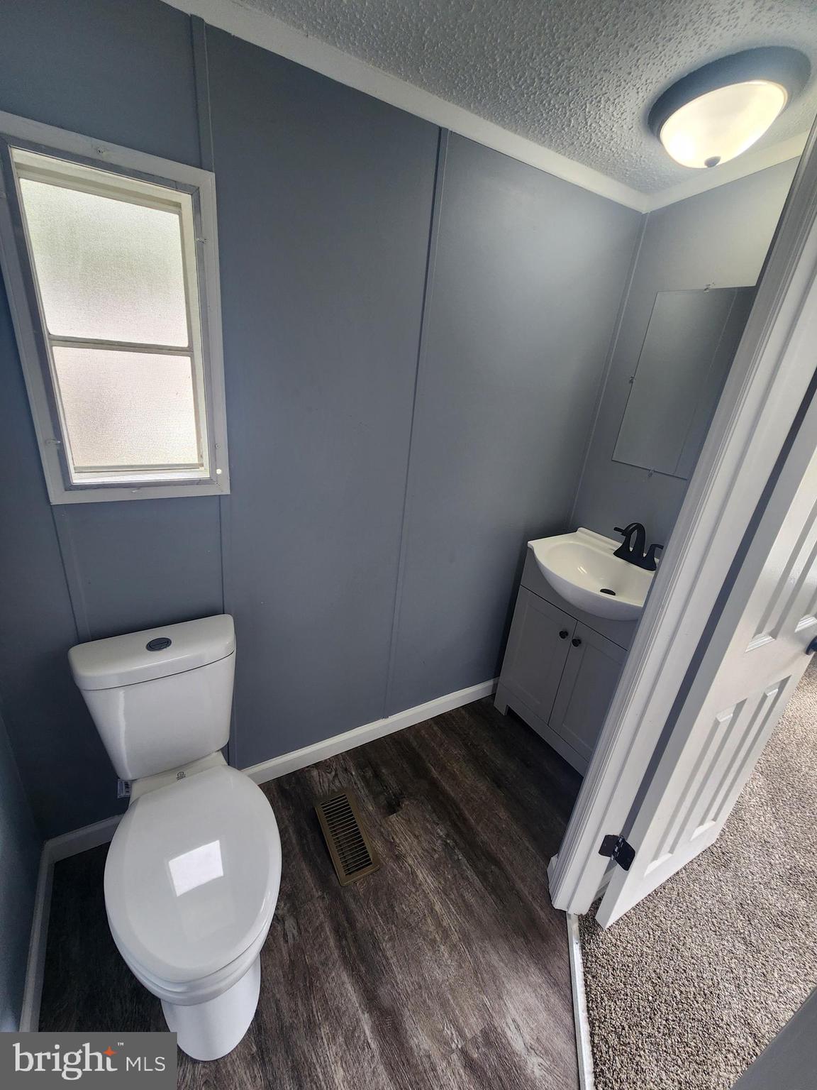 2110 Mays Landing Road, Unit 161 Millville, NJ 08332 - Photo 11 of 12 a bathroom with a toilet and a sink