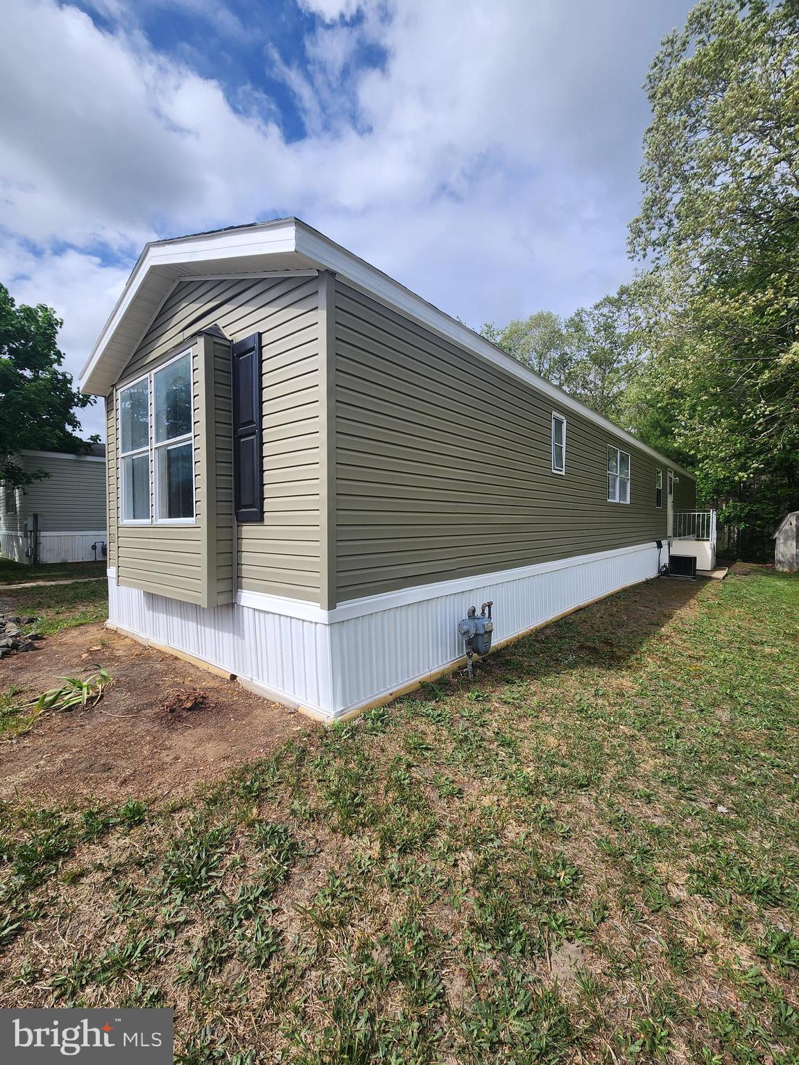 2110 Mays Landing Road, Unit 161 Millville, NJ 08332 - Photo 2 of 12 a front view of a house with a yard