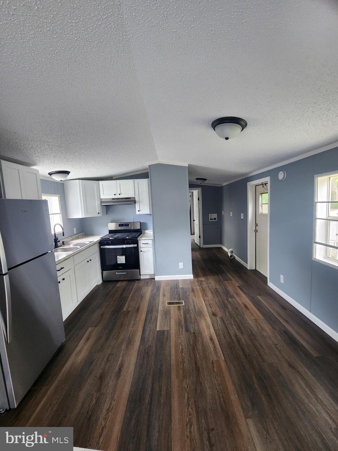 2110 Mays Landing Road, Unit 161 Millville, NJ 08332 - Photo 7 of 12 a kitchen with wooden floors and refrigerator