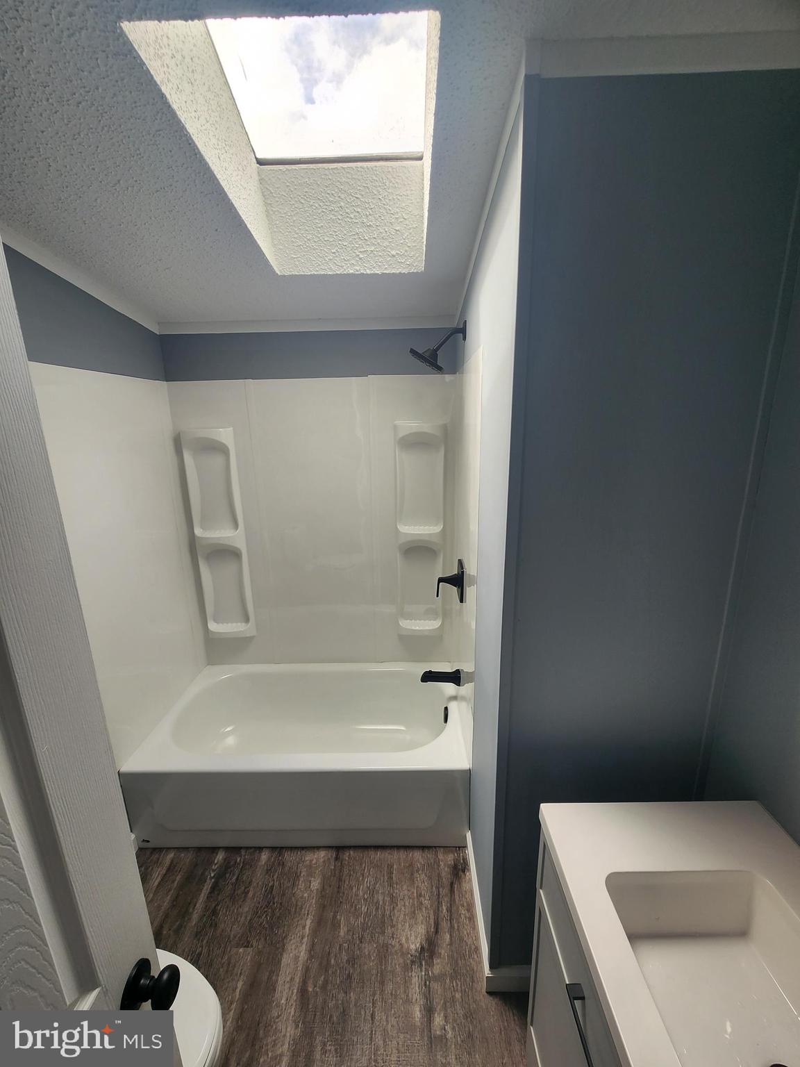 2110 Mays Landing Road, Unit 161 Millville, NJ 08332 - Photo 8 of 12 a bathroom with a tub a sink and a toilet