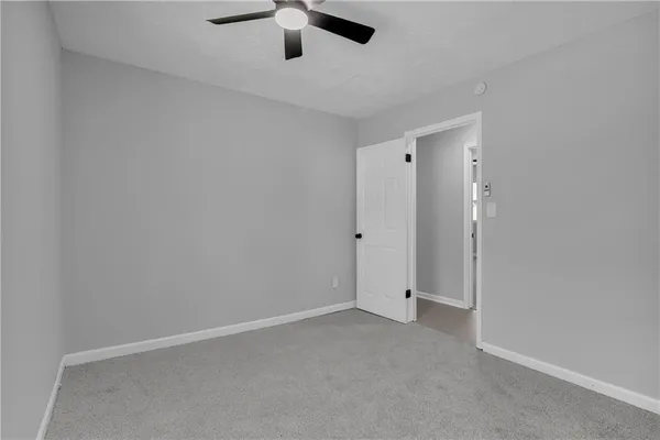 an empty room with ceiling fan