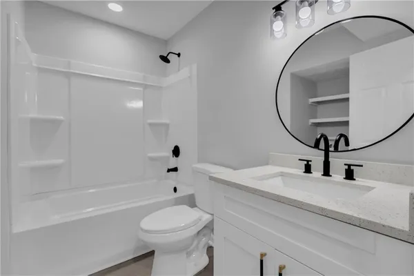 a bathroom with a sink a toilet and a mirror