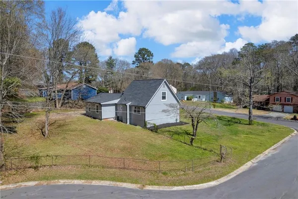 an aerial view of a residential apartment building with a yard
