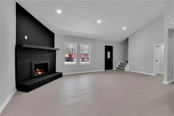a view of an empty room with a fireplace