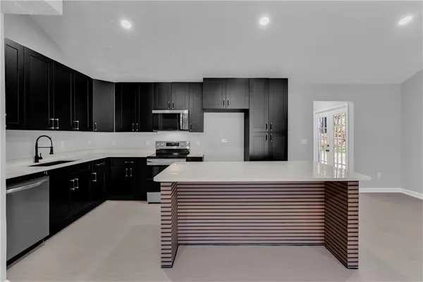 a kitchen with a refrigerator and a sink