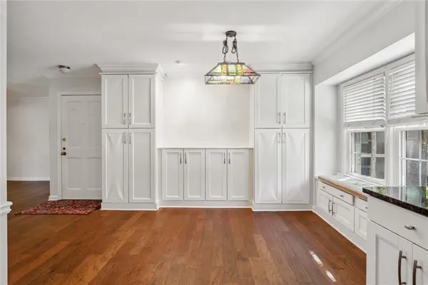 a view of empty room with wooden floor and fireplace