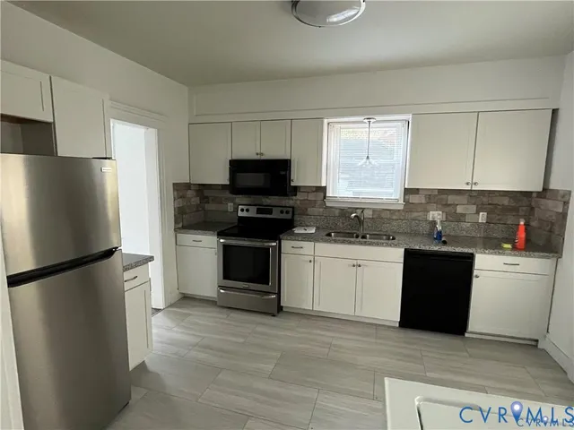a kitchen with a refrigerator stove and microwave