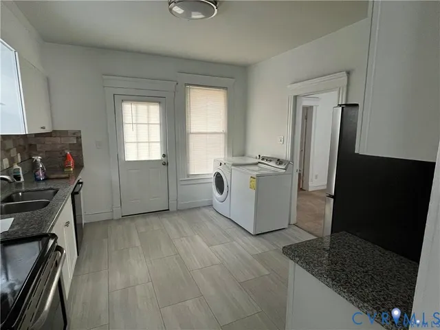 a kitchen with stainless steel appliances granite countertop a stove a refrigerator and a microwave