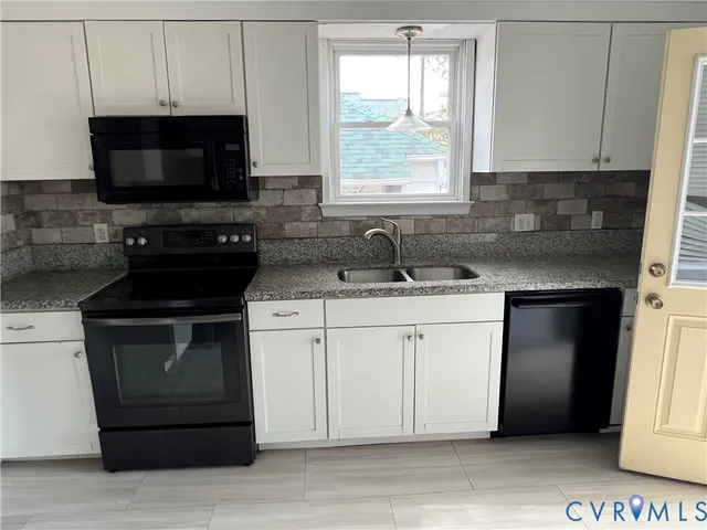 a kitchen with a sink stove and microwave