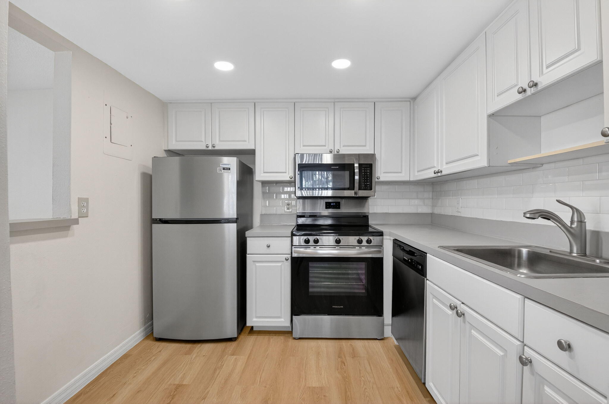 51 Flanders B Delray Beach, FL 33484 - Photo 1 of 36 a kitchen with a refrigerator sink and cabinets