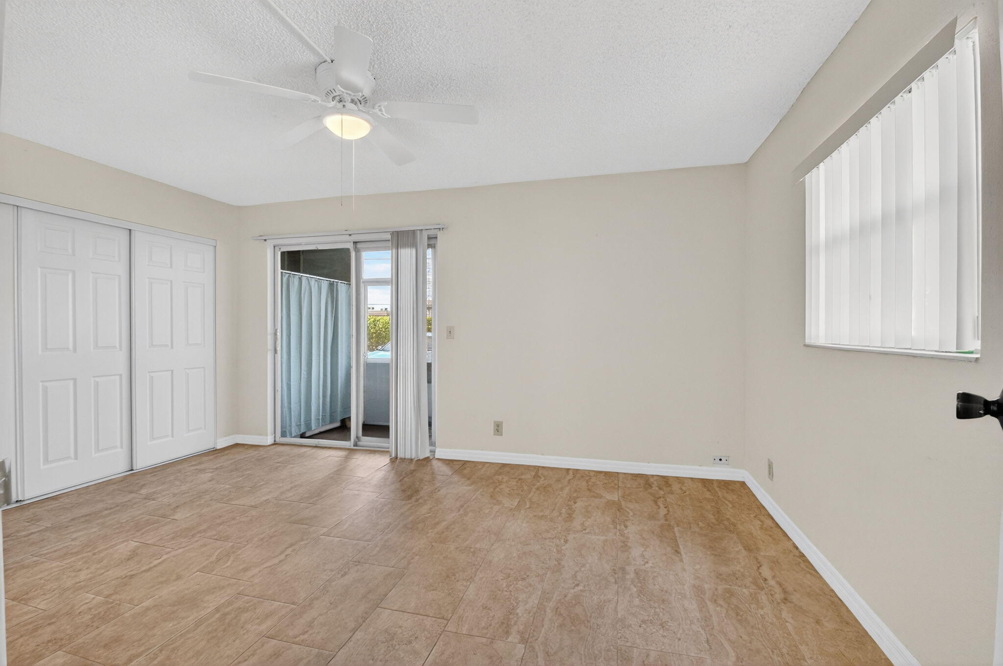 51 Flanders B Delray Beach, FL 33484 - Photo 12 of 36 wooden floor in an empty room with a window