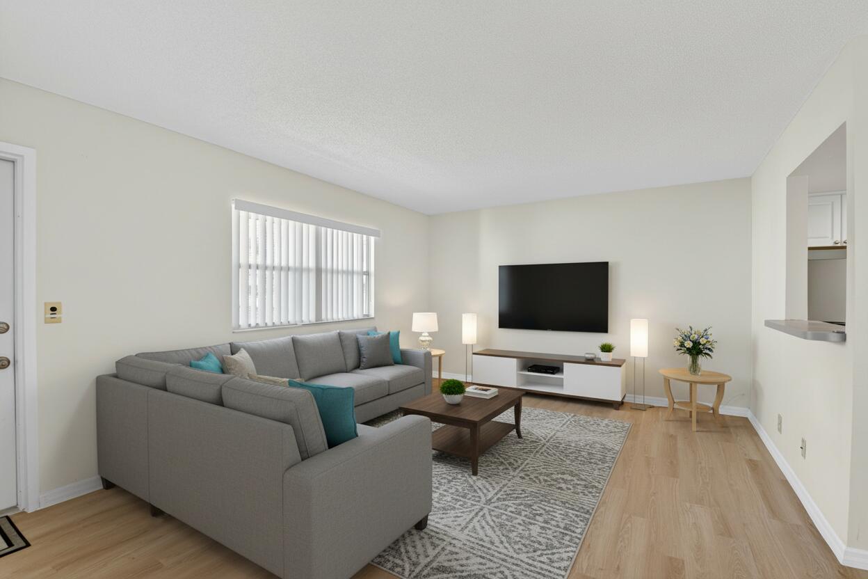 51 Flanders B Delray Beach, FL 33484 - Photo 2 of 36 a living room with furniture and a flat screen tv