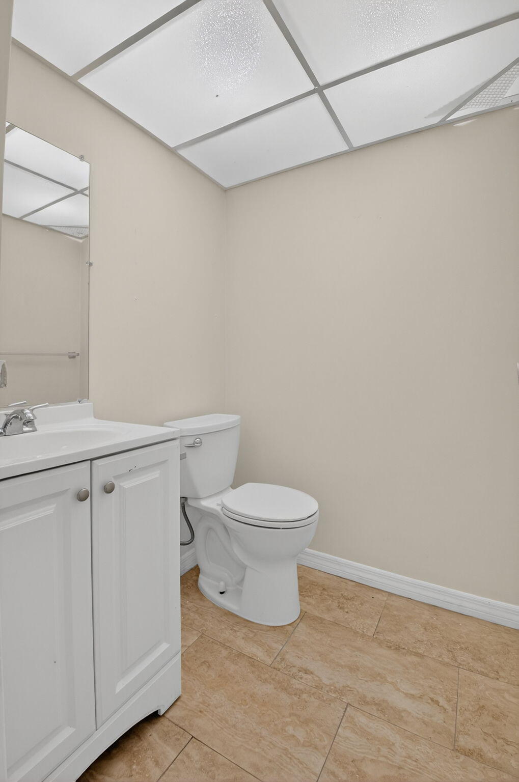 51 Flanders B Delray Beach, FL 33484 - Photo 10 of 36 a white toilet sitting next to a bathroom sink