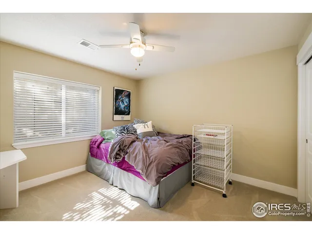 a spacious bedroom with a bed and window