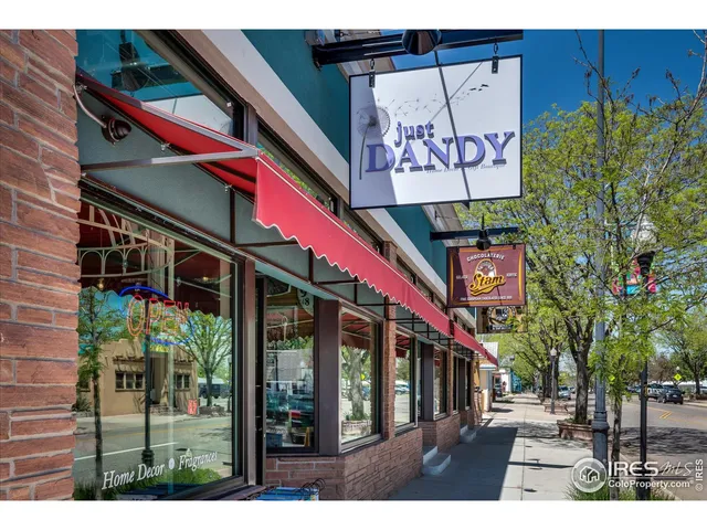 a sign board with tall buildings