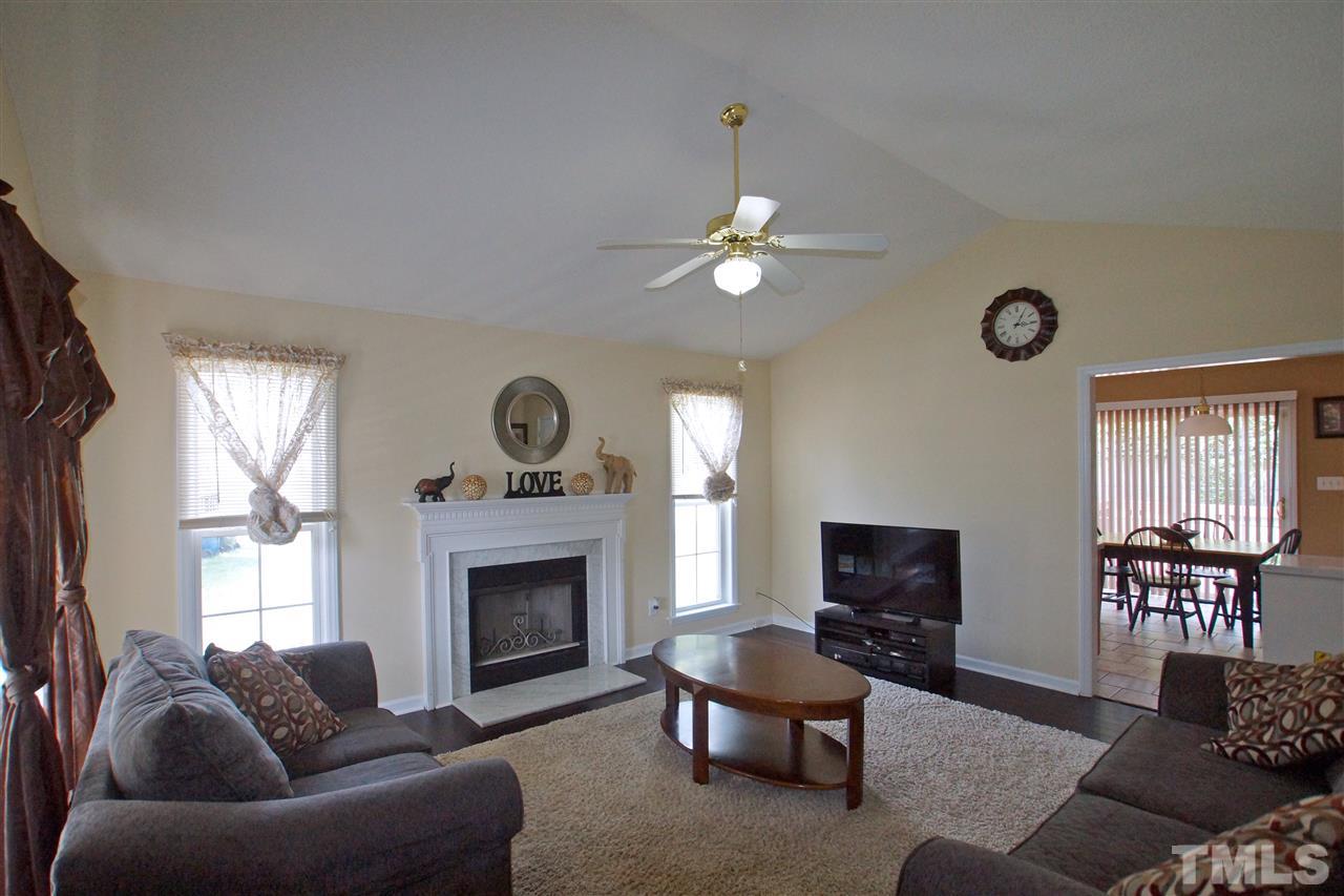 Living room with fireplace and hardwoods.