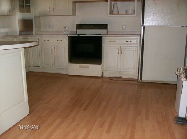 102 West Millbury Road Sutton, MA 01590 - Photo 19 of 24 a kitchen with a sink cabinets and a wooden floor