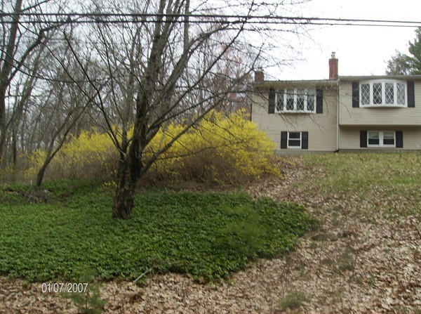 102 West Millbury Road Sutton, MA 01590 - Photo 22 of 24 a view of a house with a yard