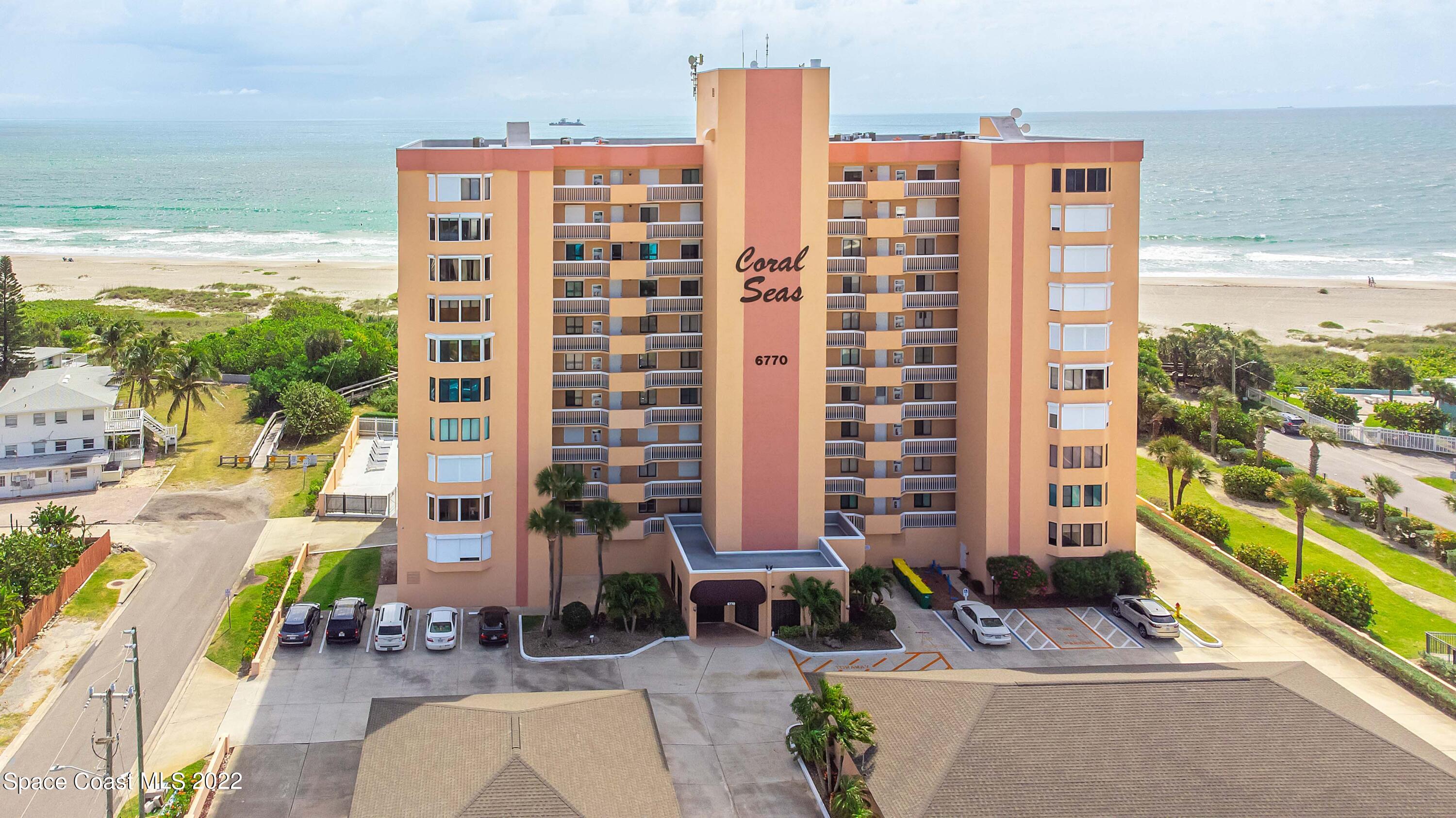 6770 Ridgewood Avenue, Unit 1001 Cocoa Beach, FL 32931 - Photo 1 of 57 a front view of a building with a outdoor space