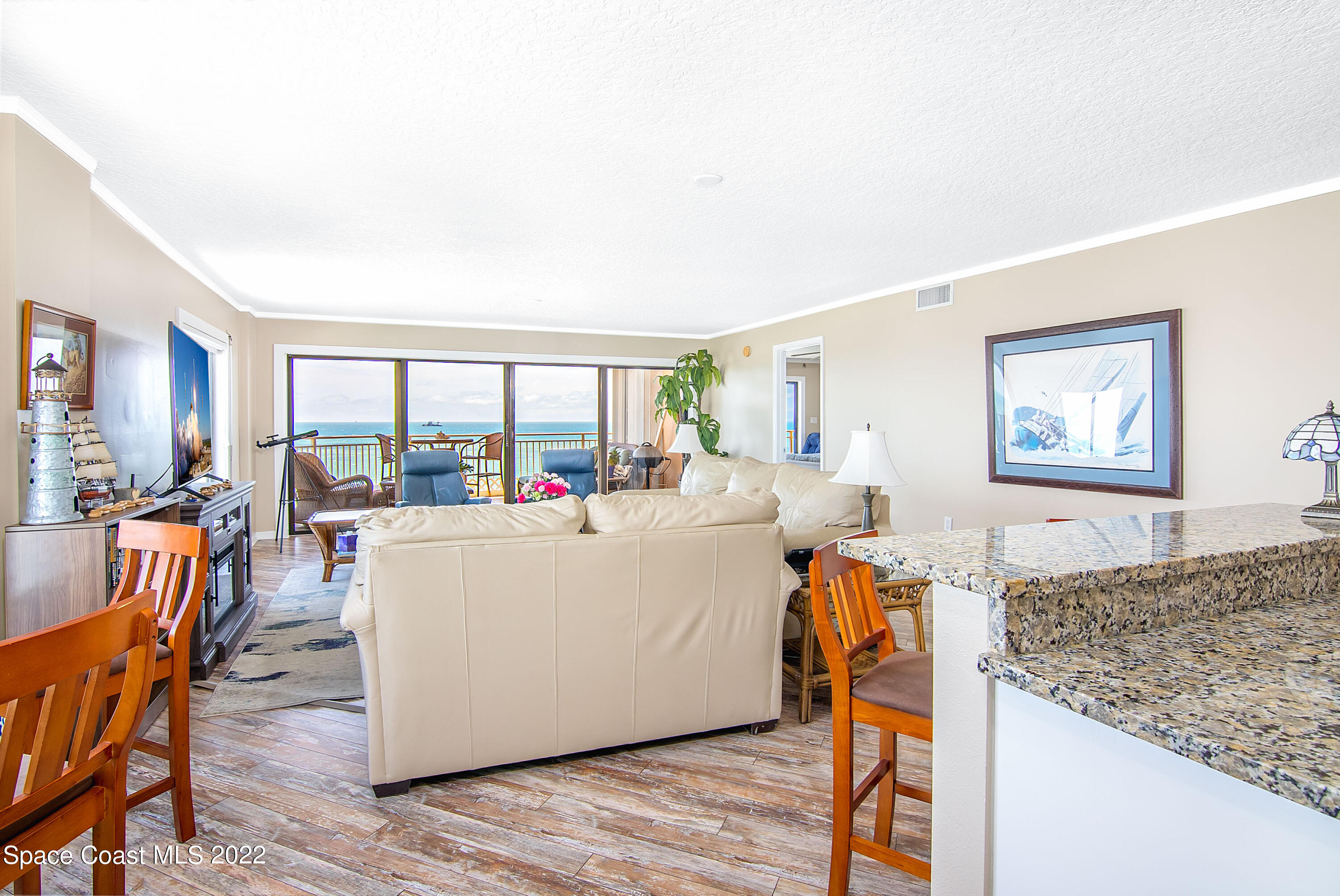 6770 Ridgewood Avenue, Unit 1001 Cocoa Beach, FL 32931 - Photo 14 of 57 a living room with furniture and a wooden floor