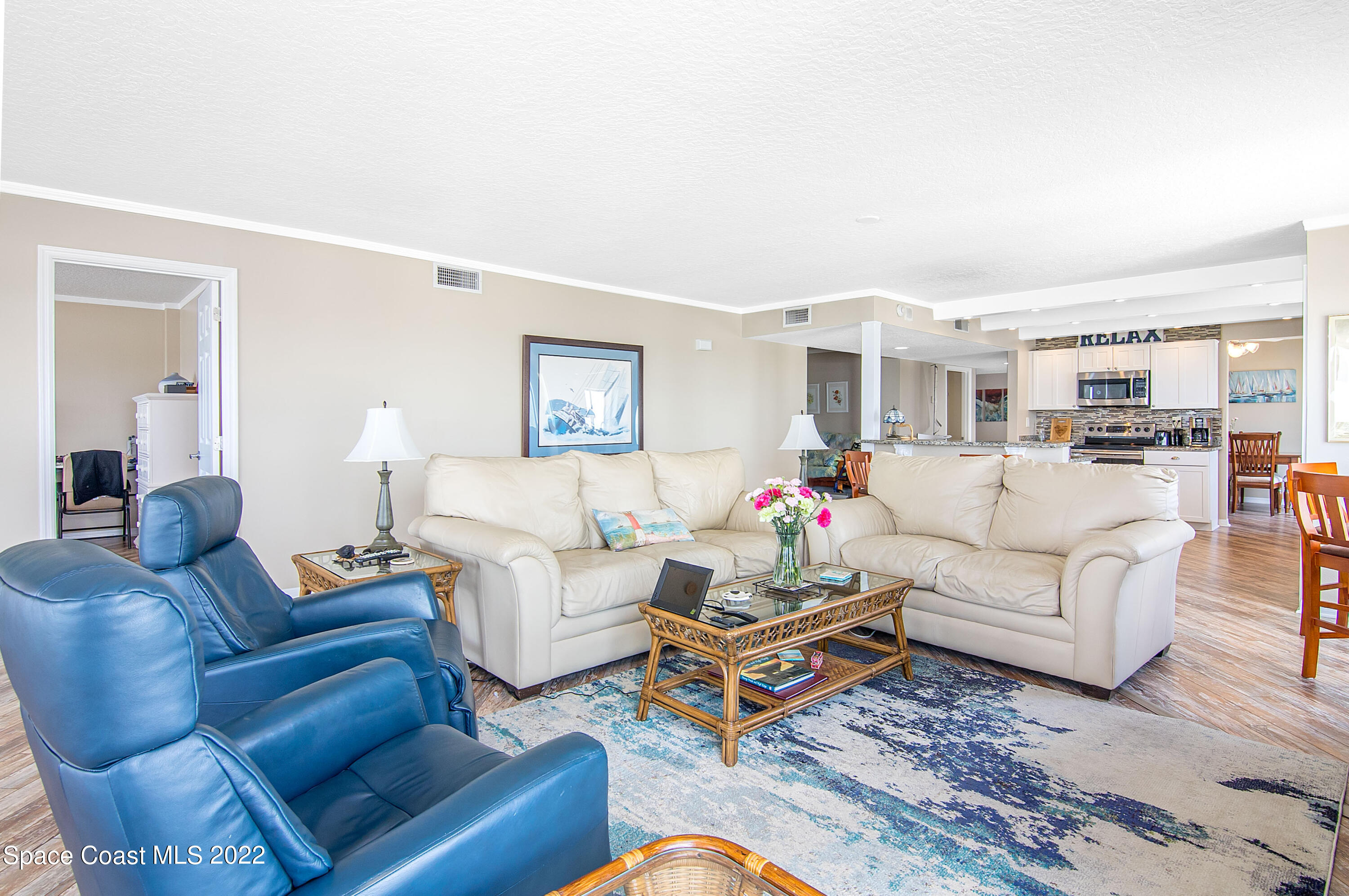 6770 Ridgewood Avenue, Unit 1001 Cocoa Beach, FL 32931 - Photo 16 of 57 a living room with furniture dining area and a table