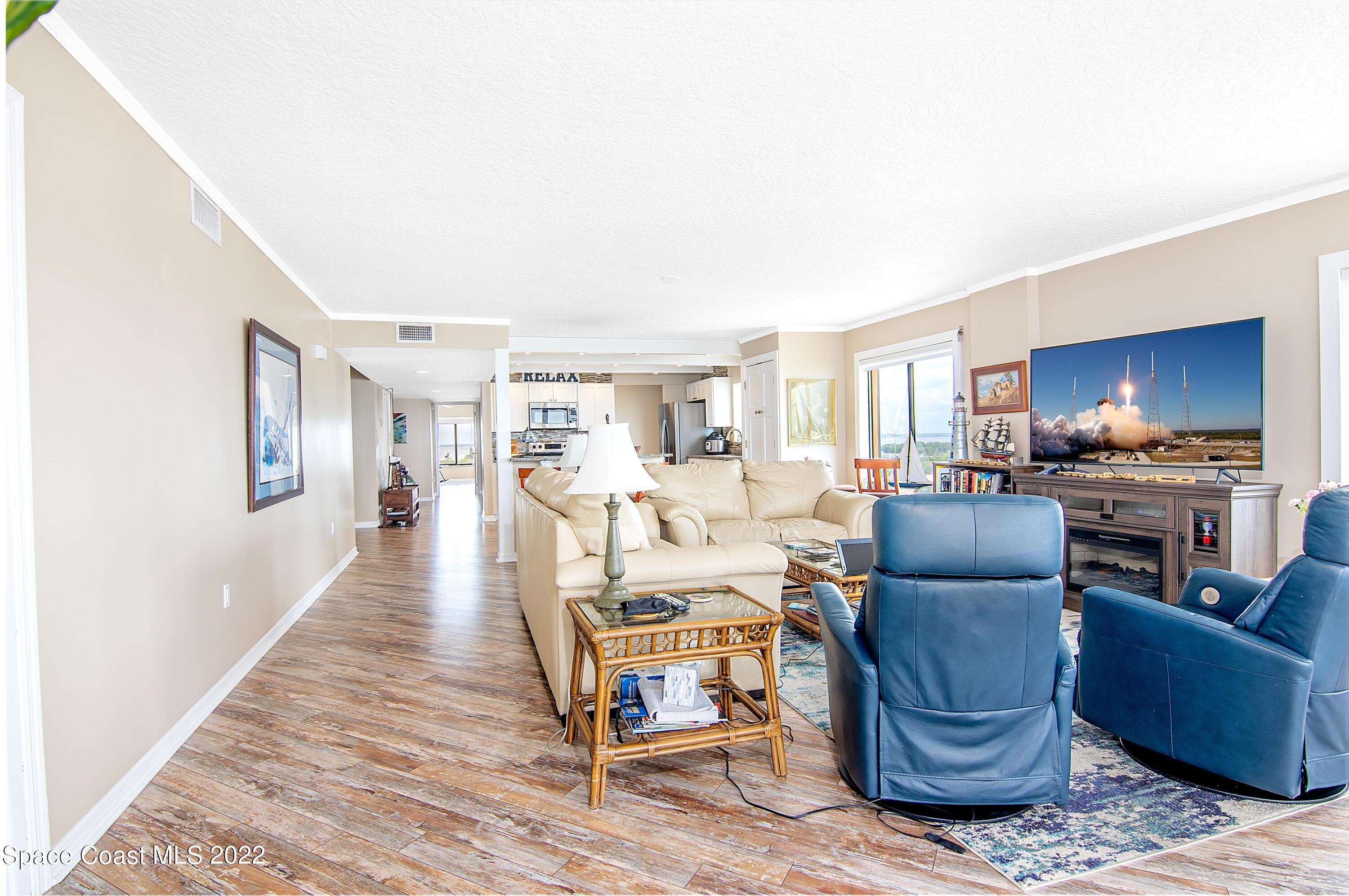 6770 Ridgewood Avenue, Unit 1001 Cocoa Beach, FL 32931 - Photo 17 of 57 a living room with furniture and a wooden floor