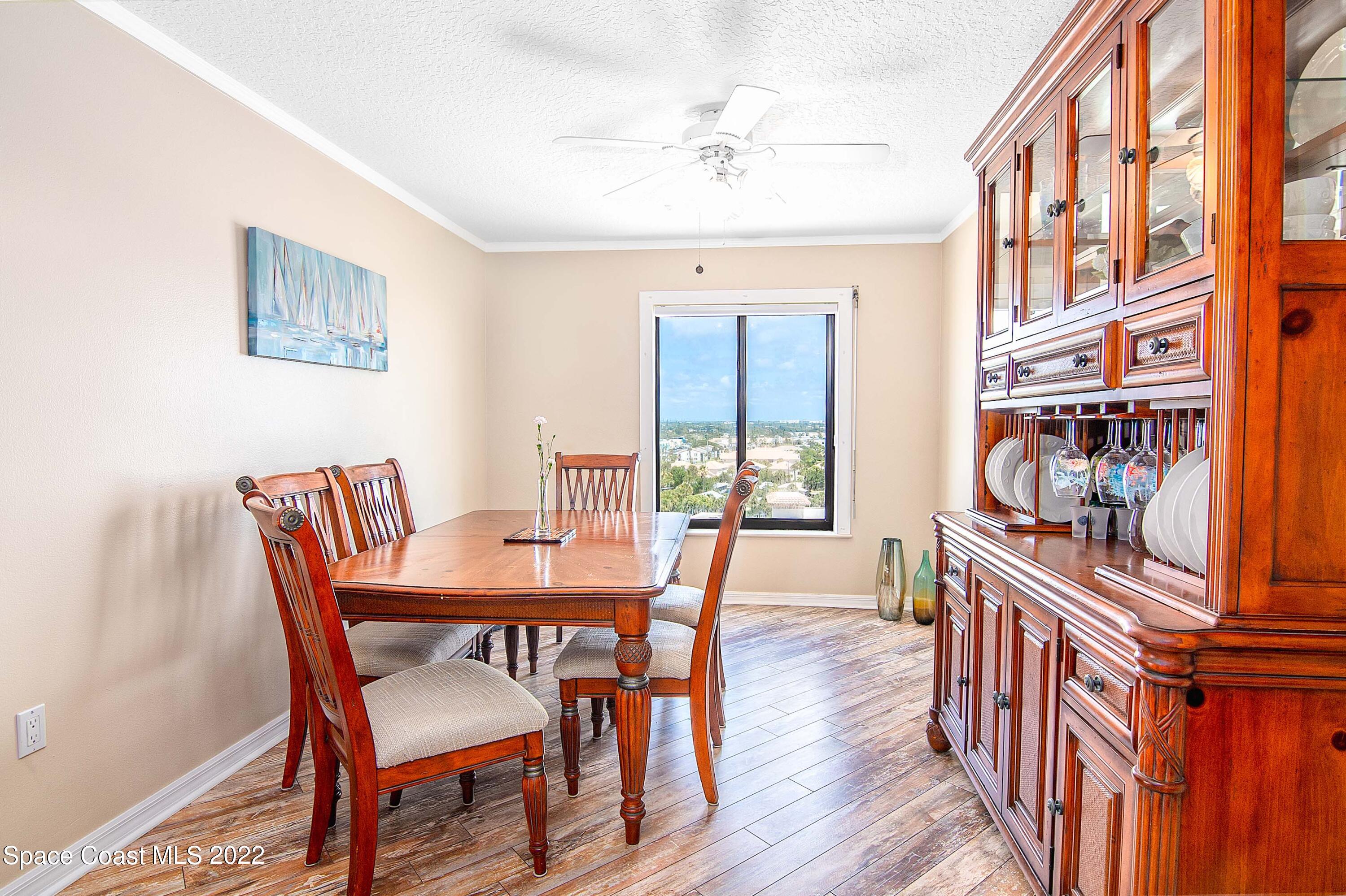 6770 Ridgewood Avenue, Unit 1001 Cocoa Beach, FL 32931 - Photo 18 of 57 a view of a dining room with furniture window and wooden floor
