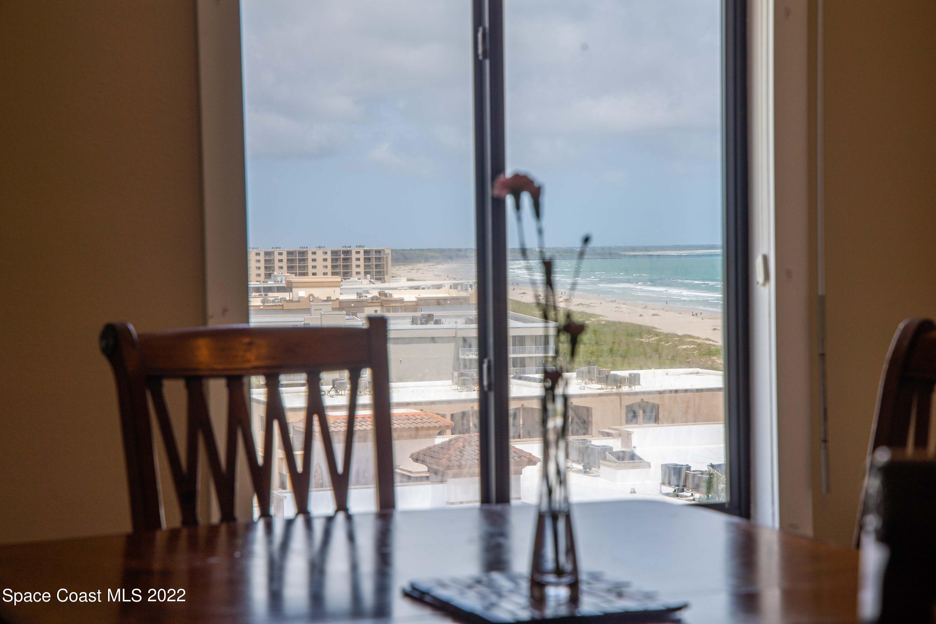 6770 Ridgewood Avenue, Unit 1001 Cocoa Beach, FL 32931 - Photo 20 of 57 a view of a living room with a floor to ceiling window
