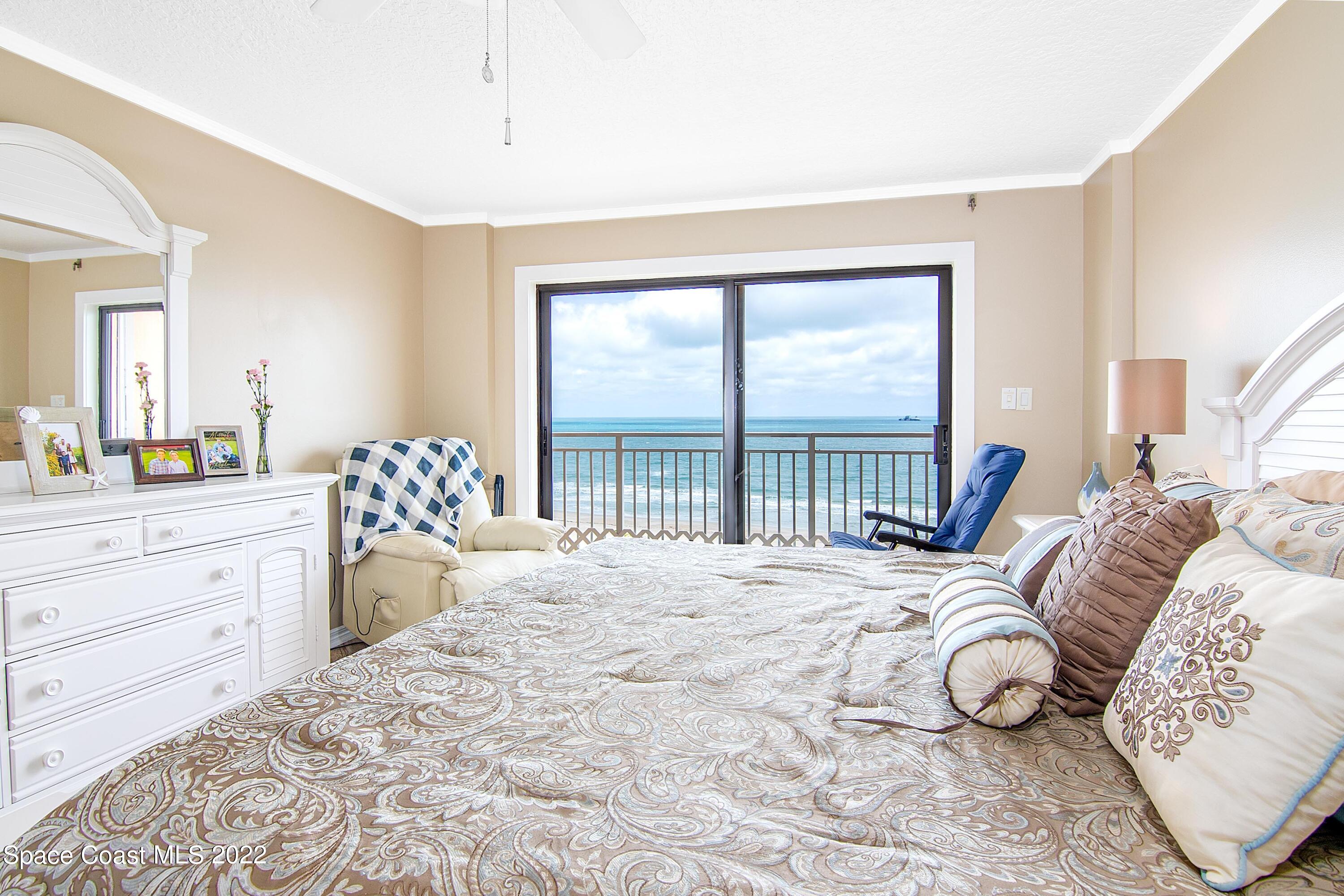 6770 Ridgewood Avenue, Unit 1001 Cocoa Beach, FL 32931 - Photo 26 of 57 a bedroom with a large bed and a large window