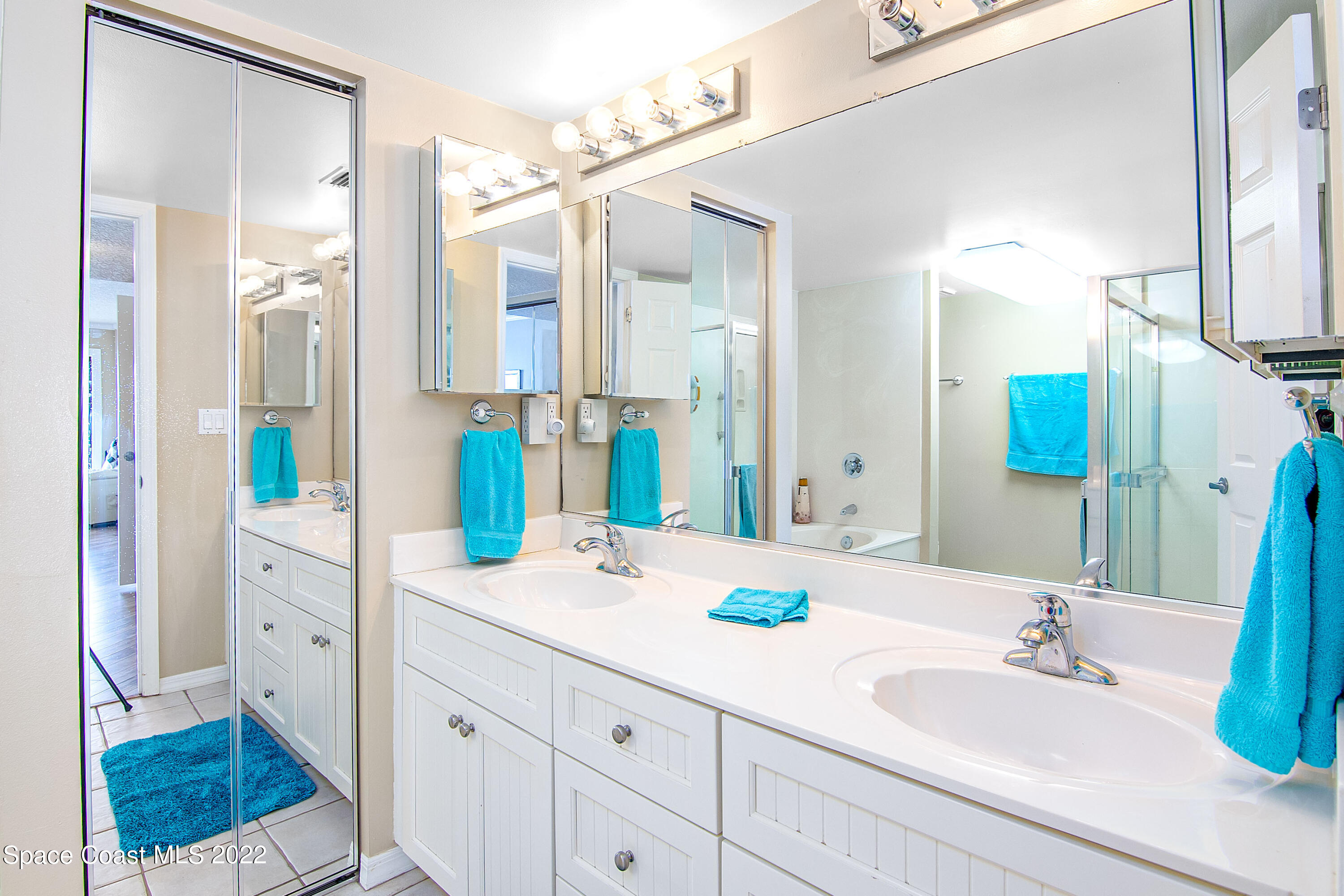 6770 Ridgewood Avenue, Unit 1001 Cocoa Beach, FL 32931 - Photo 27 of 57 a bathroom with a sink and a mirror
