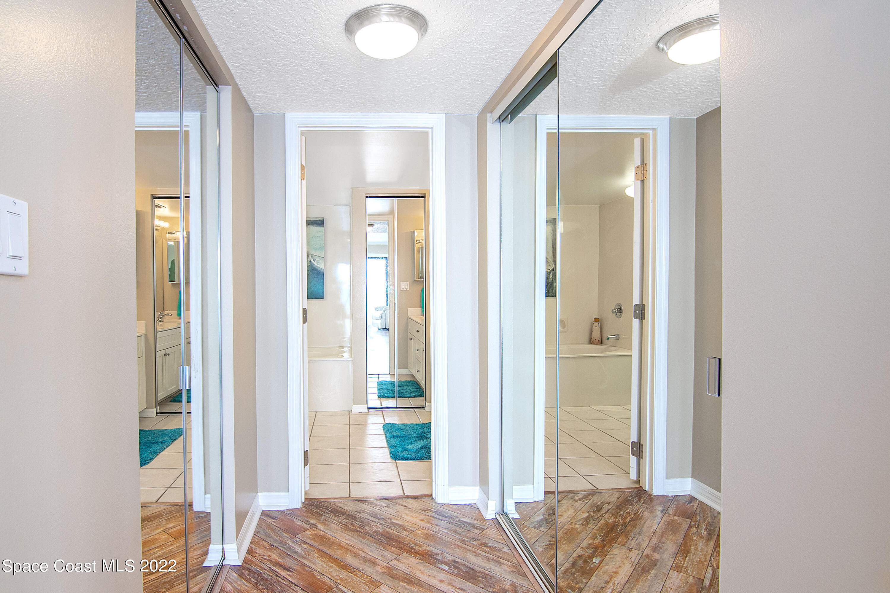 6770 Ridgewood Avenue, Unit 1001 Cocoa Beach, FL 32931 - Photo 29 of 57 CS Primary Bedroom Twin Closet & Bath Ha