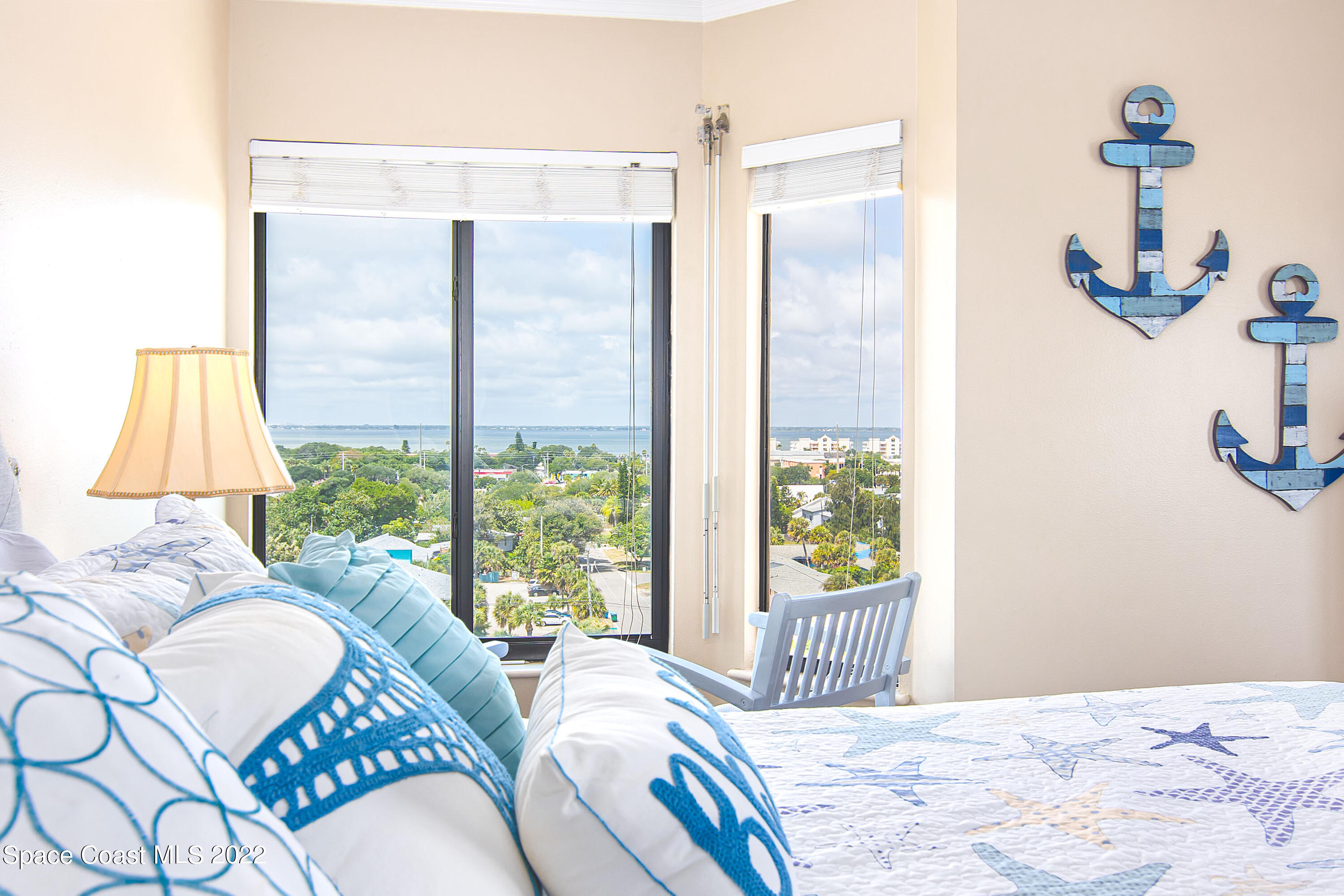 6770 Ridgewood Avenue, Unit 1001 Cocoa Beach, FL 32931 - Photo 31 of 57 a bedroom with a bed and a window