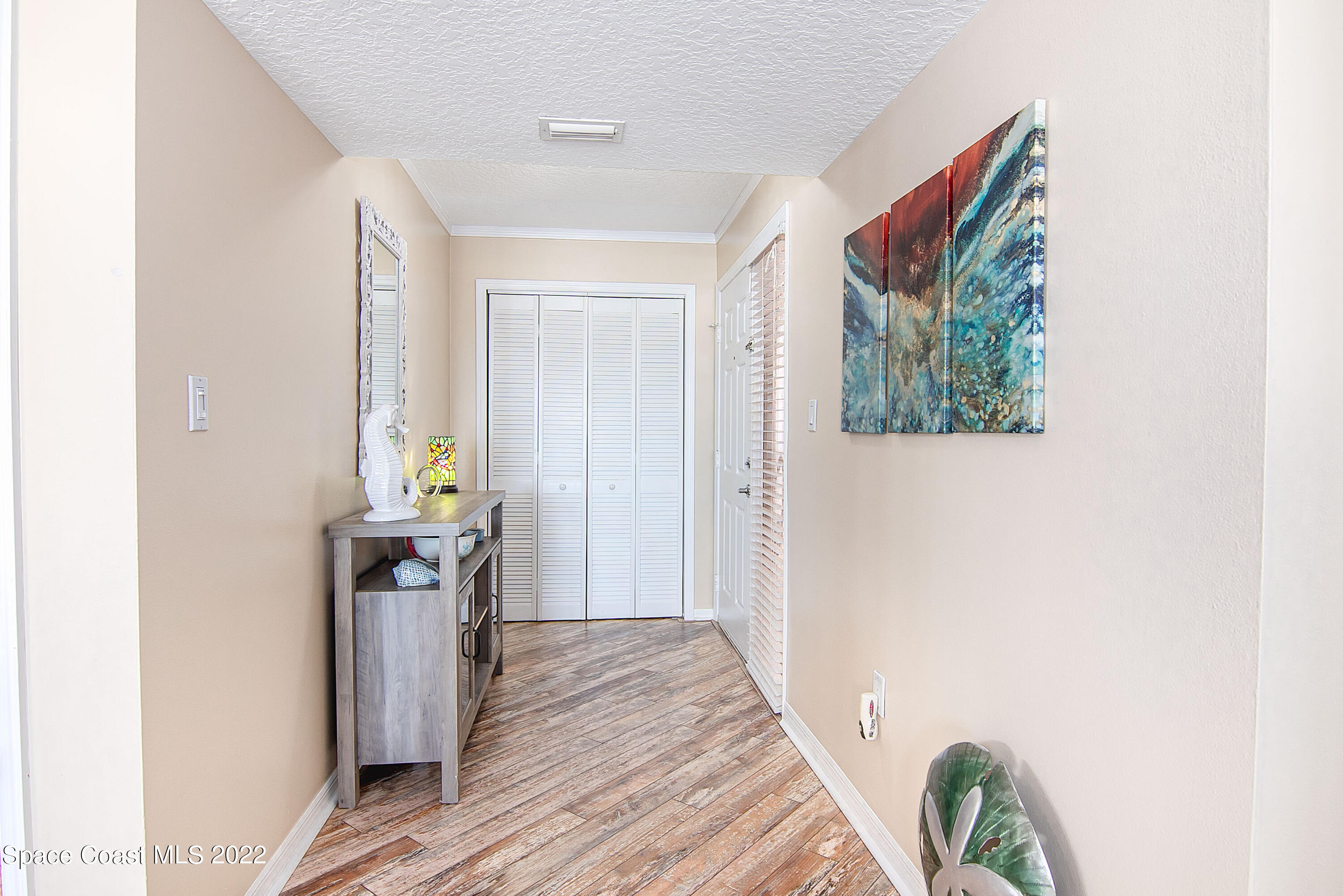 6770 Ridgewood Avenue, Unit 1001 Cocoa Beach, FL 32931 - Photo 39 of 57 a view of hallway with wooden floor