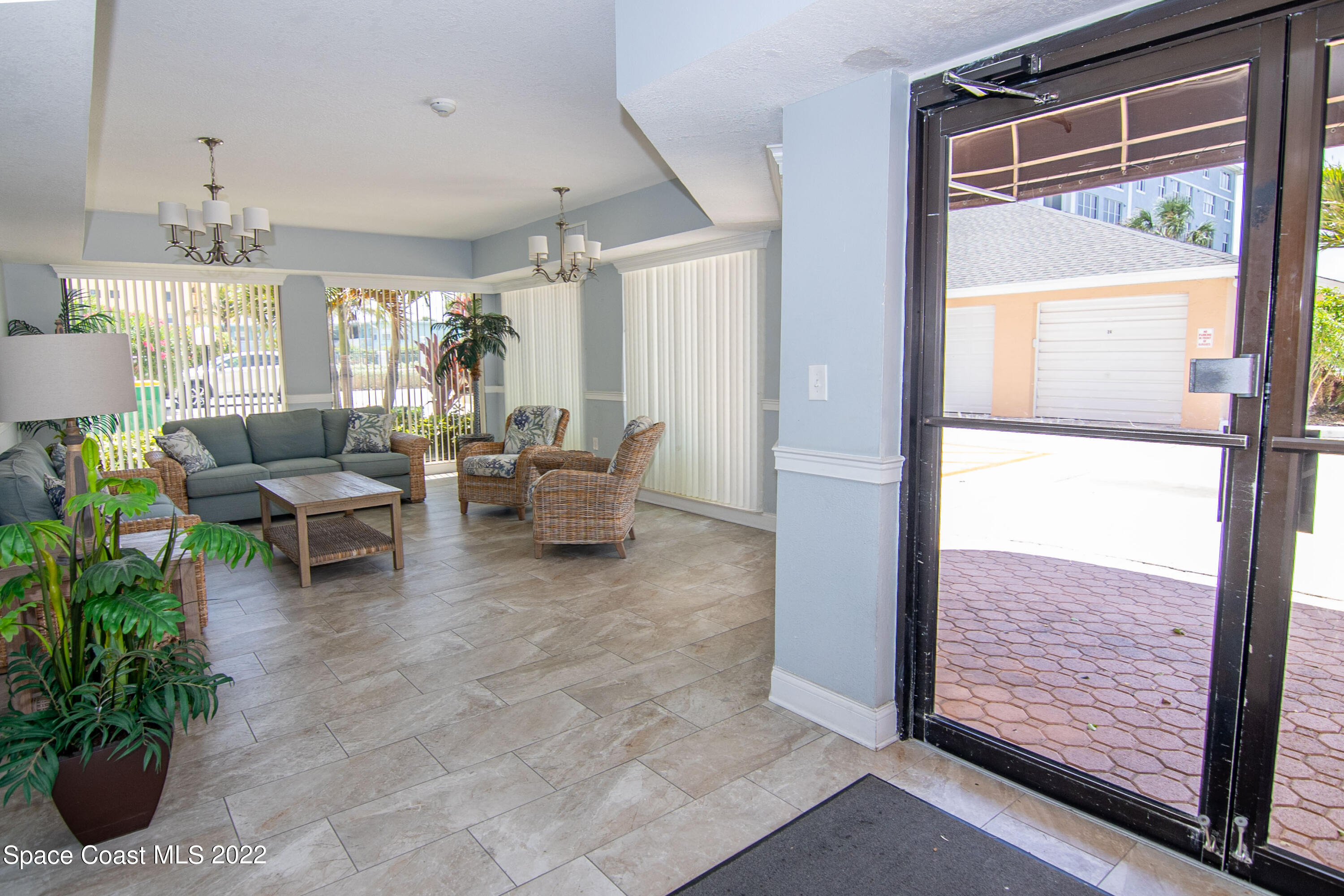 6770 Ridgewood Avenue, Unit 1001 Cocoa Beach, FL 32931 - Photo 42 of 57 a living room with furniture and a potted plant