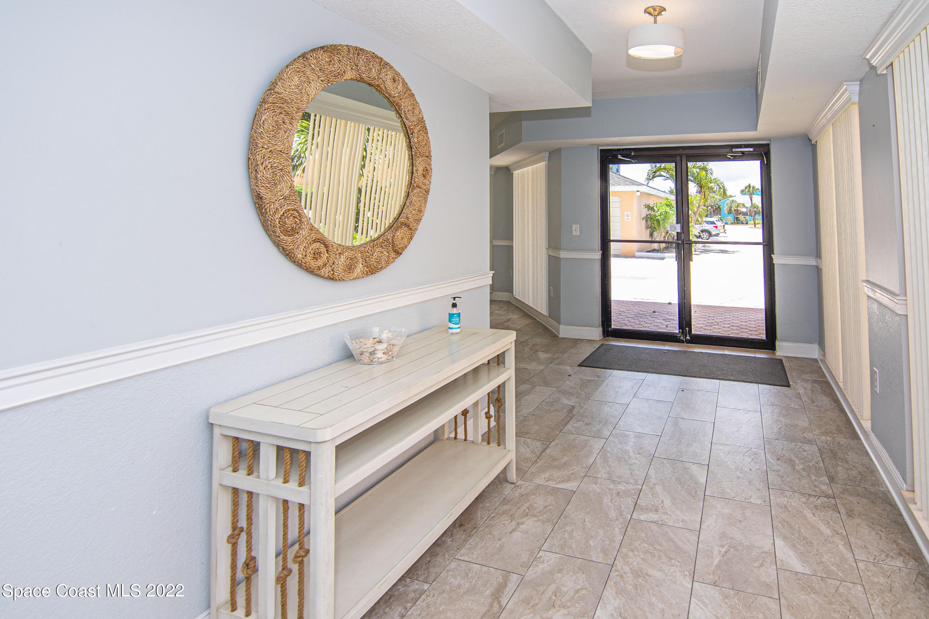 6770 Ridgewood Avenue, Unit 1001 Cocoa Beach, FL 32931 - Photo 43 of 57 a bathroom with a sink and a mirror