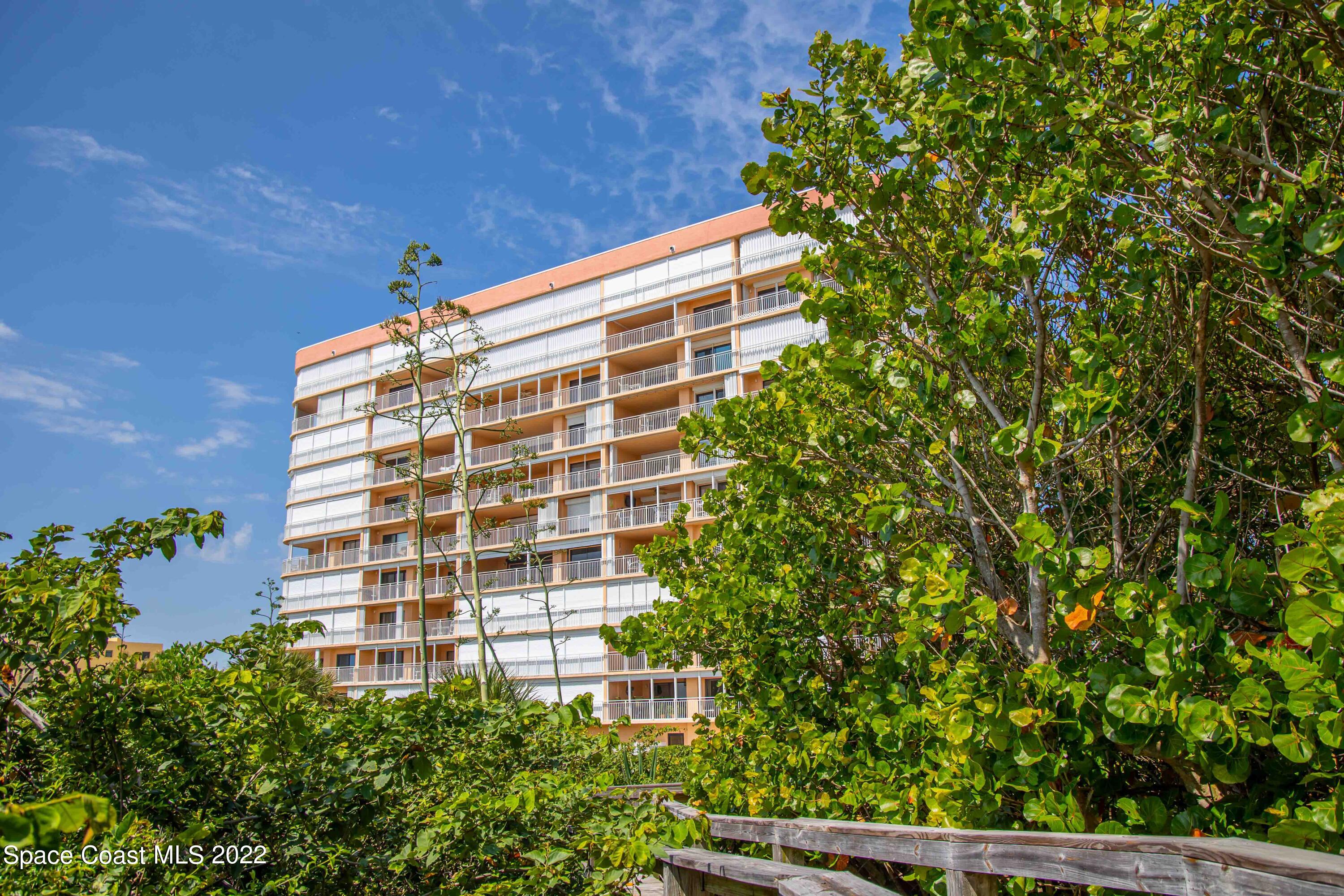 6770 Ridgewood Avenue, Unit 1001 Cocoa Beach, FL 32931 - Photo 49 of 57 a front view of a building with an outdoor space