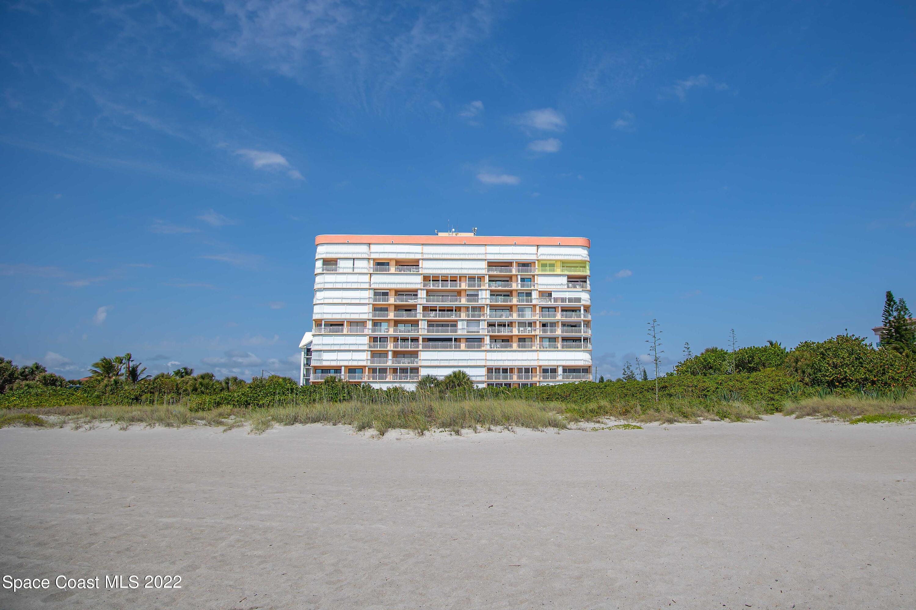 6770 Ridgewood Avenue, Unit 1001 Cocoa Beach, FL 32931 - Photo 51 of 57 a front view of a house with a yard and lake view