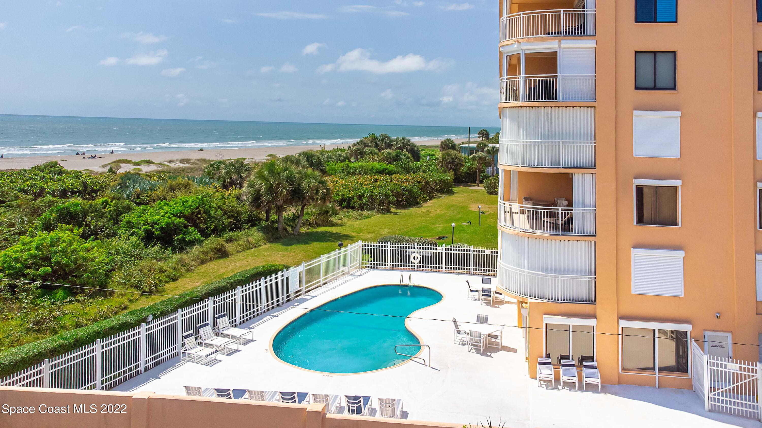 6770 Ridgewood Avenue, Unit 1001 Cocoa Beach, FL 32931 - Photo 6 of 57 a view of a swimming pool with a balcony