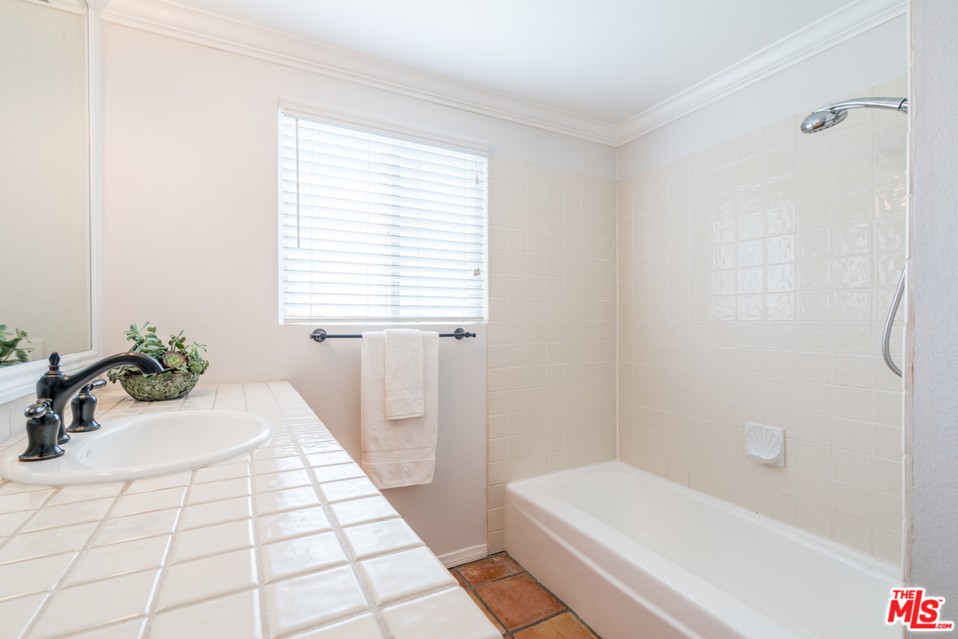 6267 Tapia Drive Malibu, CA 90265 - Photo 13 of 16 a bathroom with a bathtub a sink and a shower
