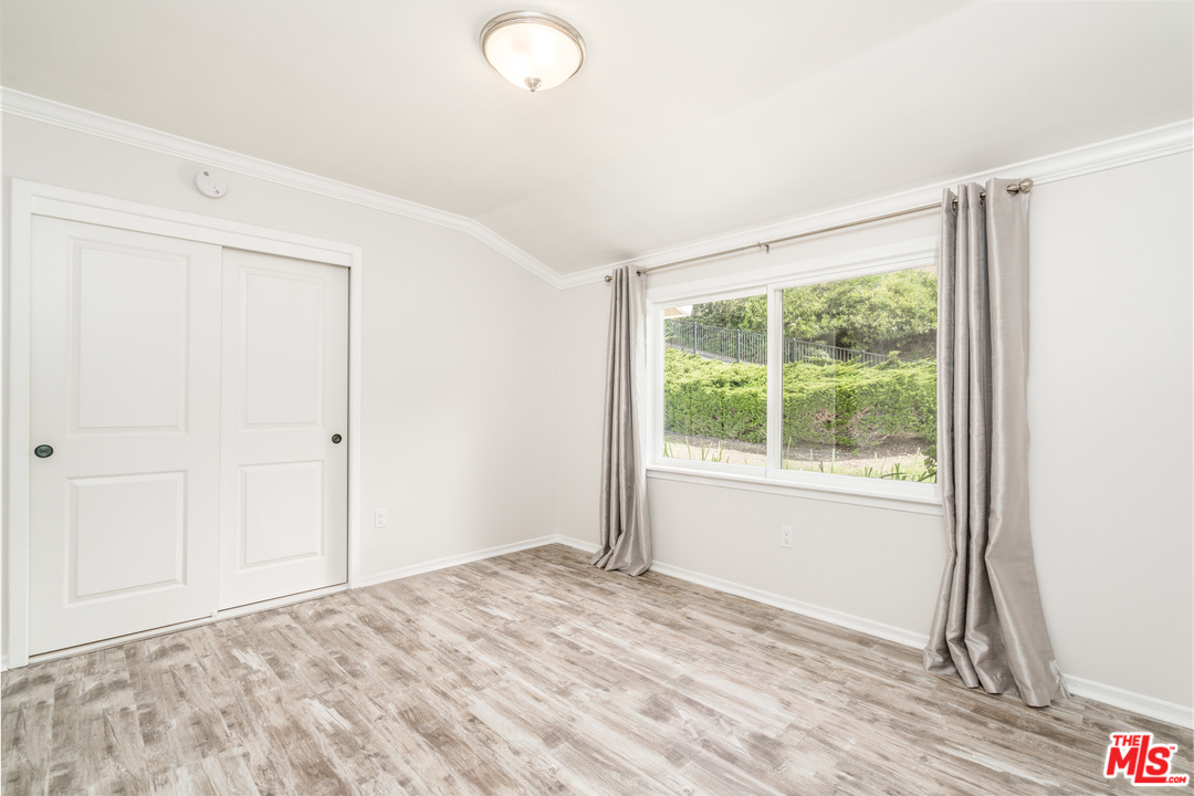 6267 Tapia Drive Malibu, CA 90265 - Photo 14 of 16 a view of empty room with wooden floor and fan