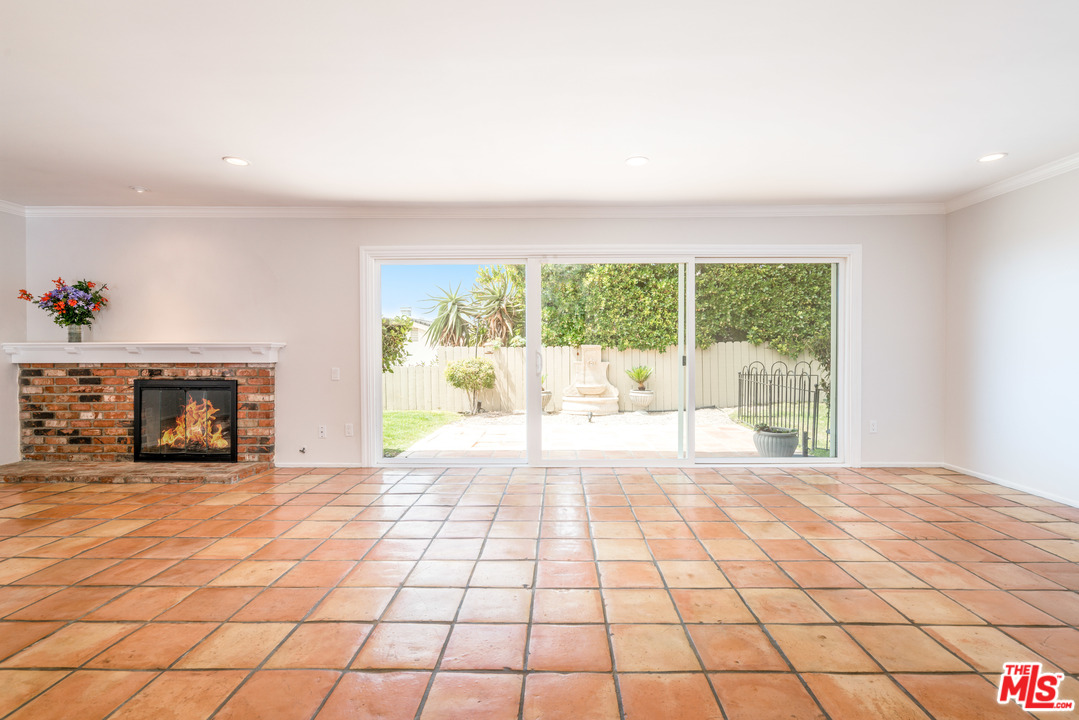 6267 Tapia Drive Malibu, CA 90265 - Photo 4 of 16 a view of an empty room with a fireplace and a large window