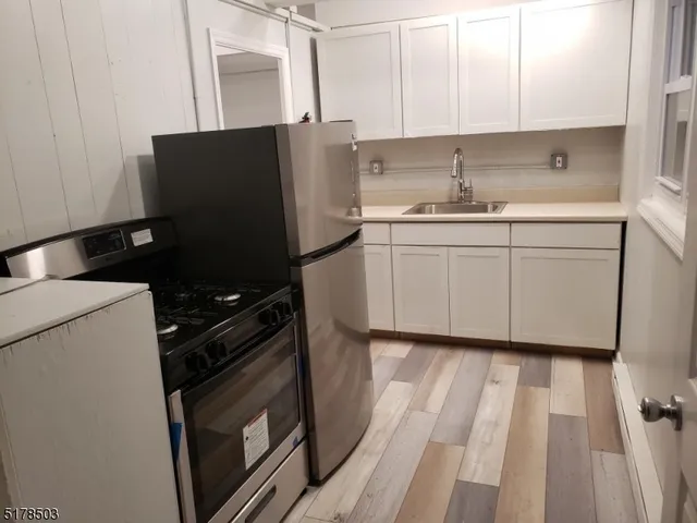 a kitchen with a sink and a stove top oven