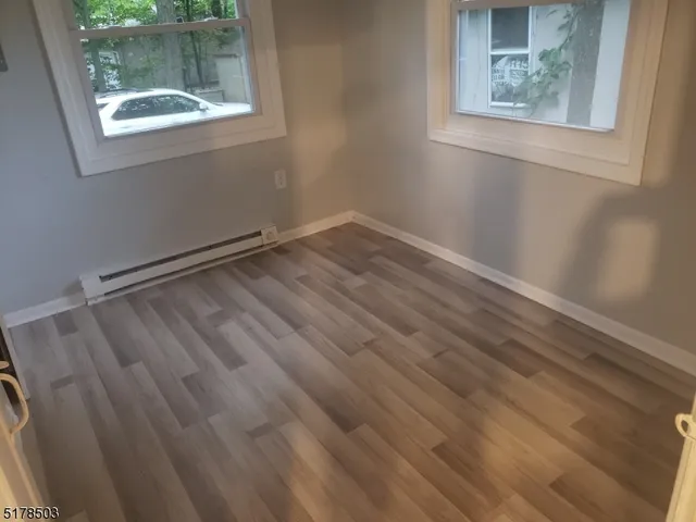 a view of room with window and hardwood floor